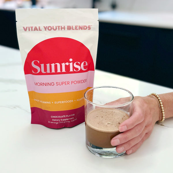 VYB Sunrise Morning Super Powder bag with chocolate-cacao powder mixed in glass — super greens powder with DIM and probiotics